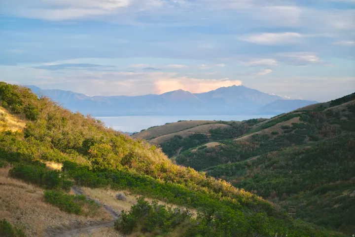 Sweeping views of Utah Lake from the surrounding SunCrest area, framed by rolling foothills and the Wasatch mountain landscape.