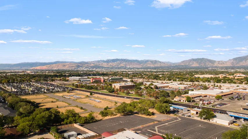 Expansive aerial perspective showcasing the property's prominent positioning within a thriving commercial and residential corridor