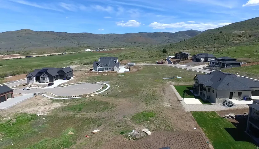 Newly developed residential area with mountain backdrop and paved roadways