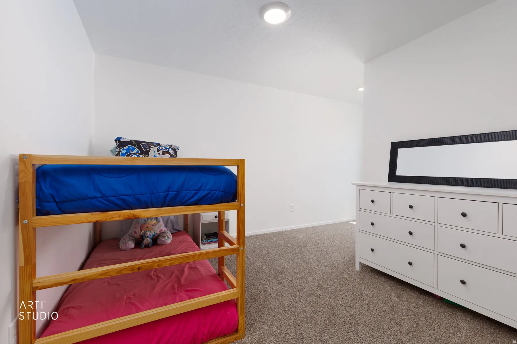 Recessed ceiling lighting, neutral carpeting, and white walls