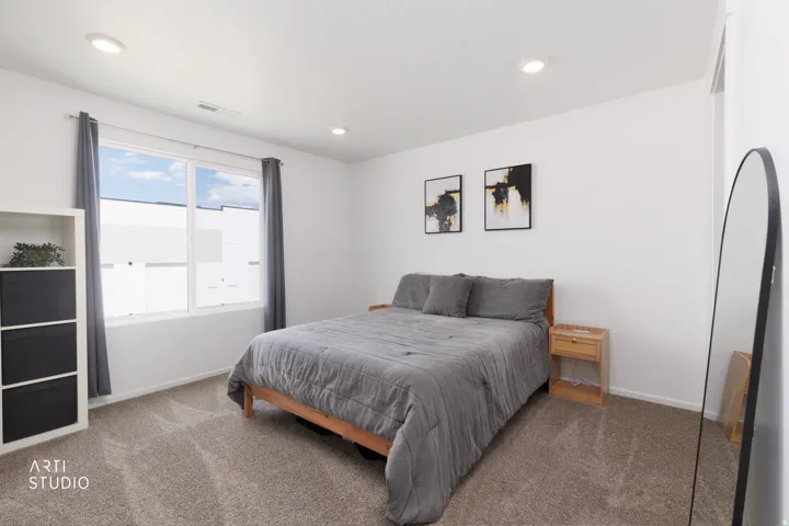 Recessed lighting, large window, and wall-to-wall carpeting
