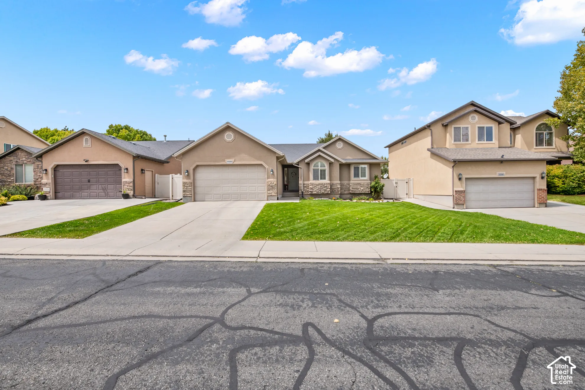 Stucco exterior with stone accents, arched windows, and a two-car garage