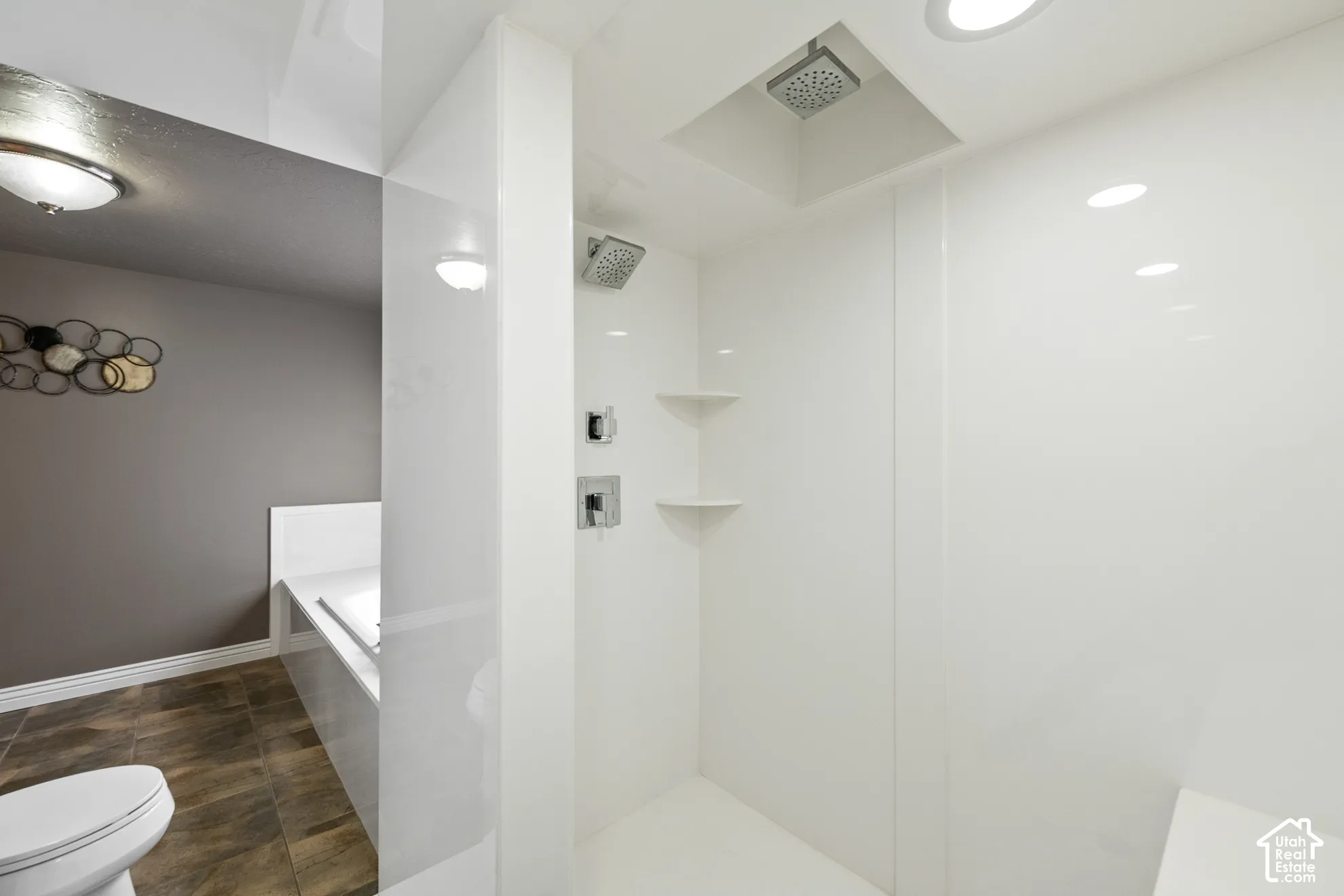 Walk-in shower with dual shower heads, recessed lighting, and integrated shelving
