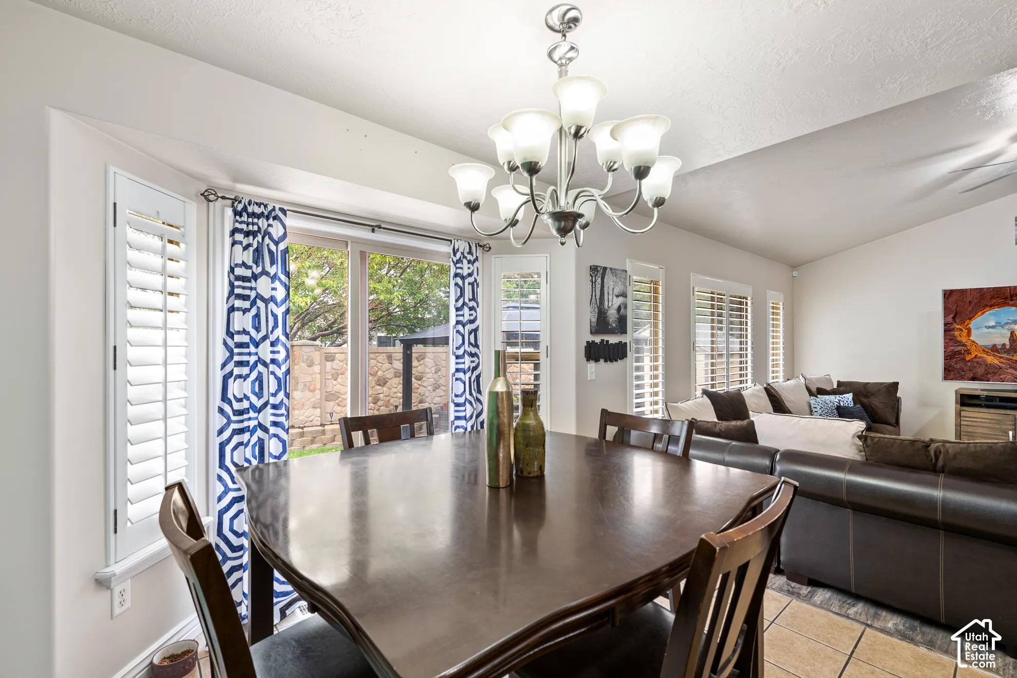 Integrated dining and living area with a vaulted ceiling
