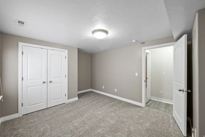 Plush carpeting and neutral wall tones