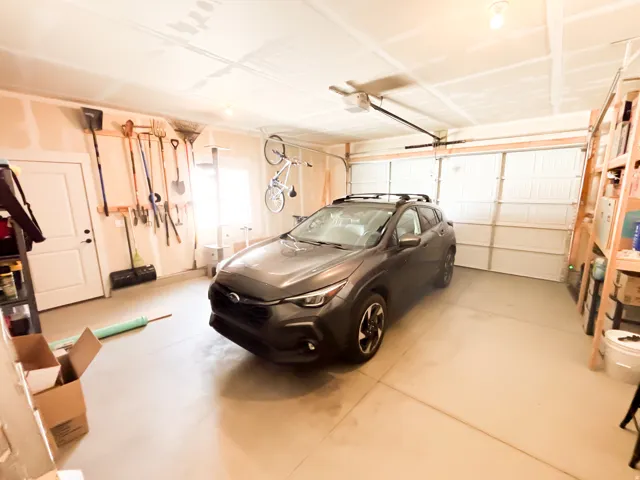 Two-car garage with a single vehicle door and overhead garage door opener