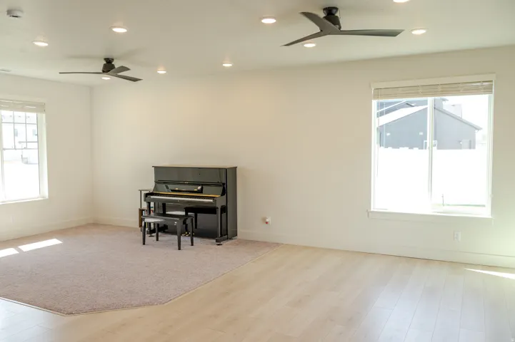 Recessed lighting, light wood-finish flooring, and multiple windows