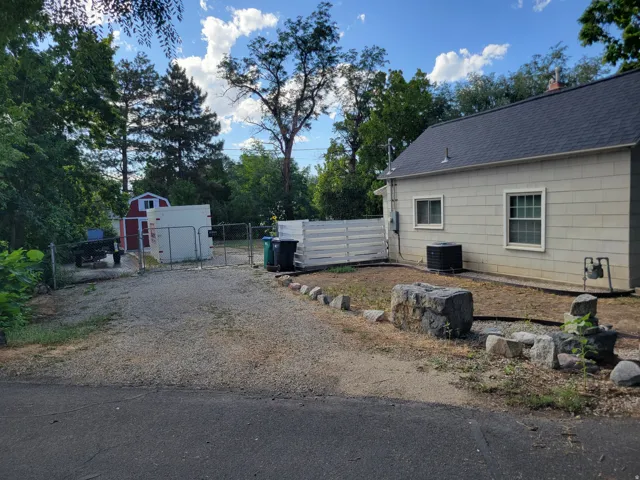 Gravel driveway leading to backyard