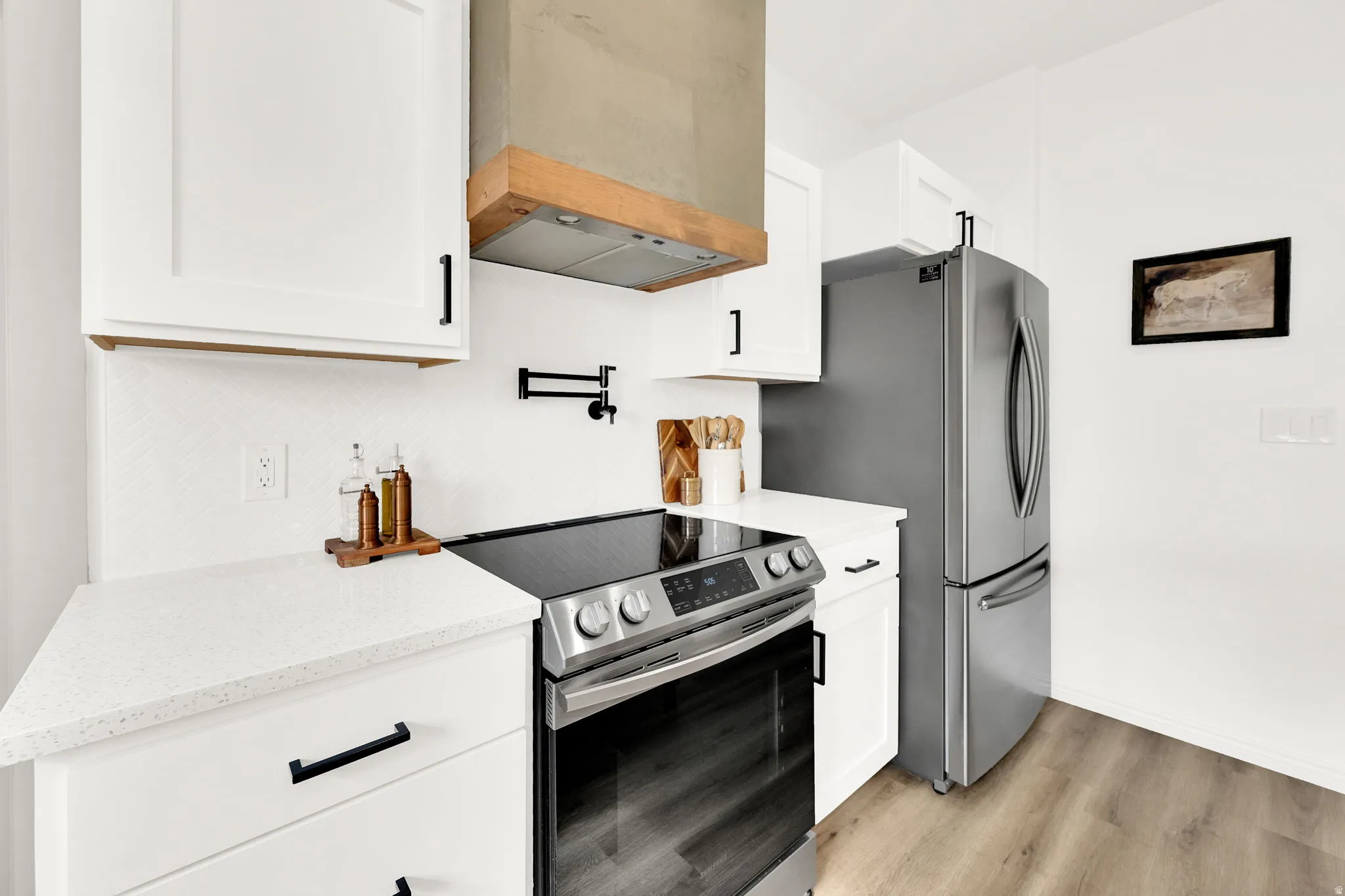 Upgraded vent hood, pot filler, herringbone tile, etc. It's the perfect place to highlight your culinary skills