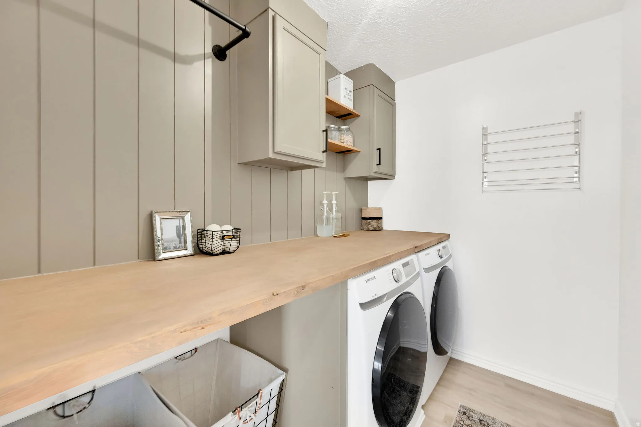 Tastefully decorated laundry room, providing the space and features to make laundry enjoyable