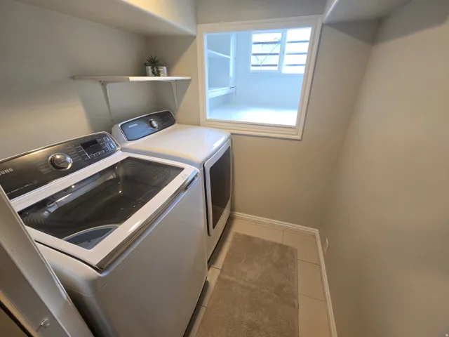 Built-in shelving, white trim window, and tile flooring