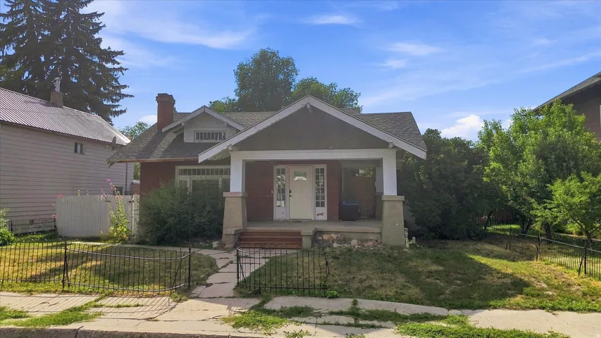 Brick exterior with a covered porch featuring white columns