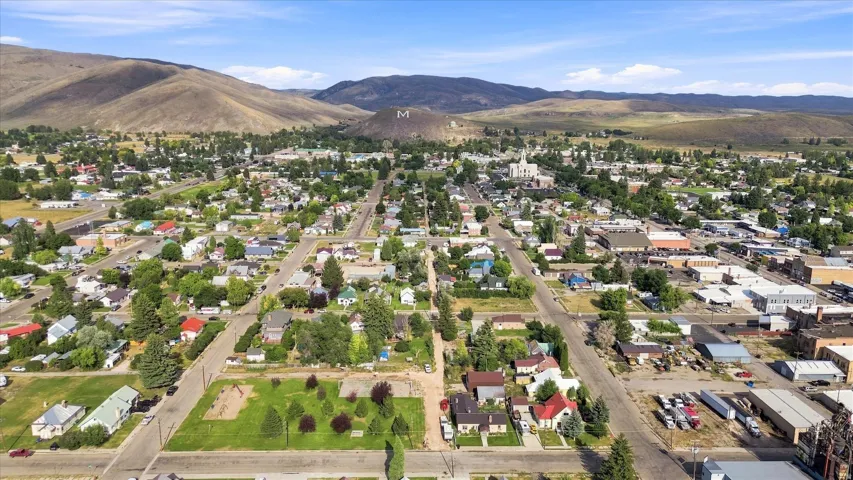 Aerial perspective showcasing a community nestled among expansive hills