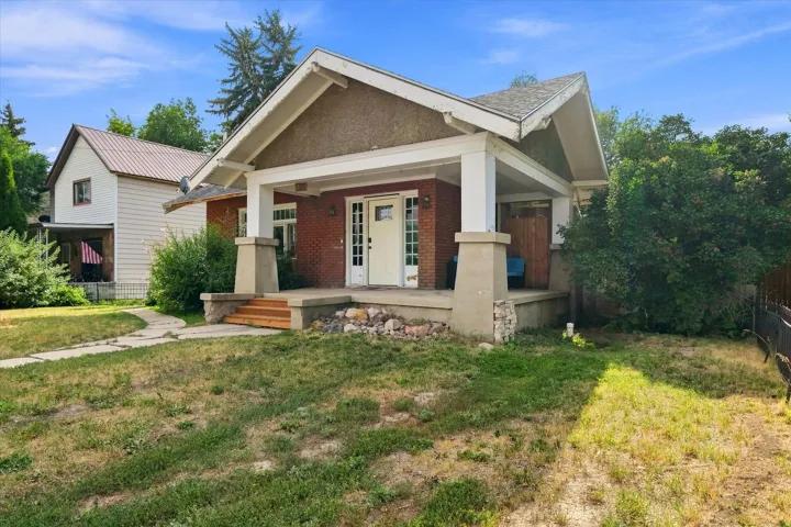 Brick exterior with a covered front porch and concrete columns