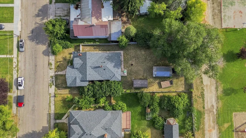 Overhead property perspective with a gray shingle roof and green landscaping