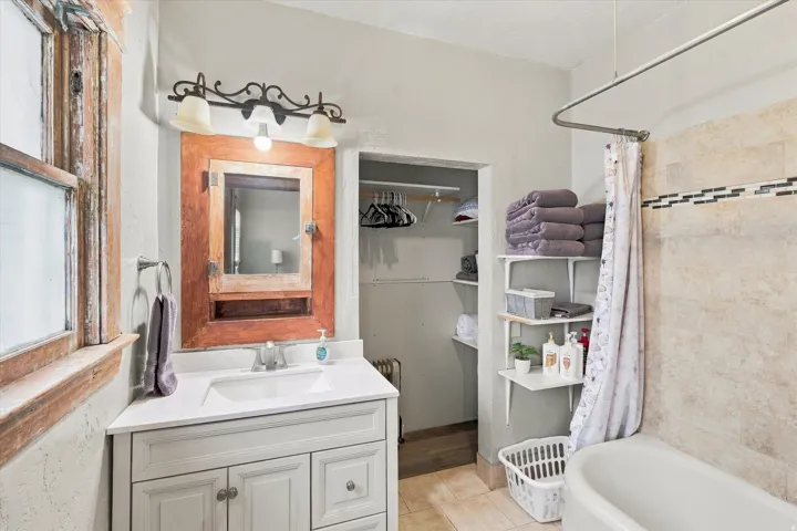White vanity with integrated sink and chrome faucet
