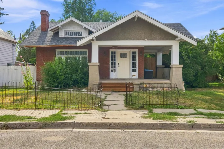 Brick exterior with a covered front porch featuring square columns