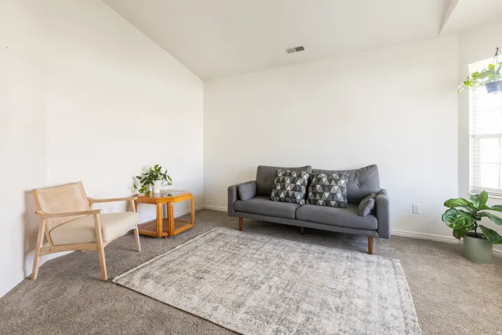 Soft gray carpeting, white walls, and window with blinds