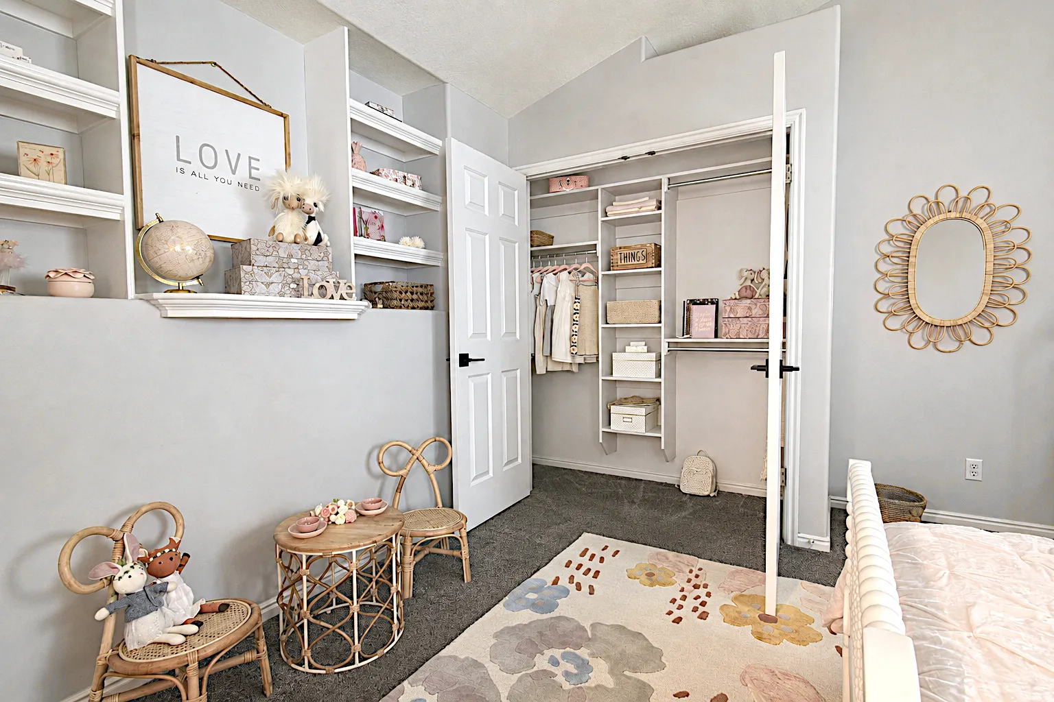 Built-in shelving, white paneled doors, black hardware, and carpet flooring