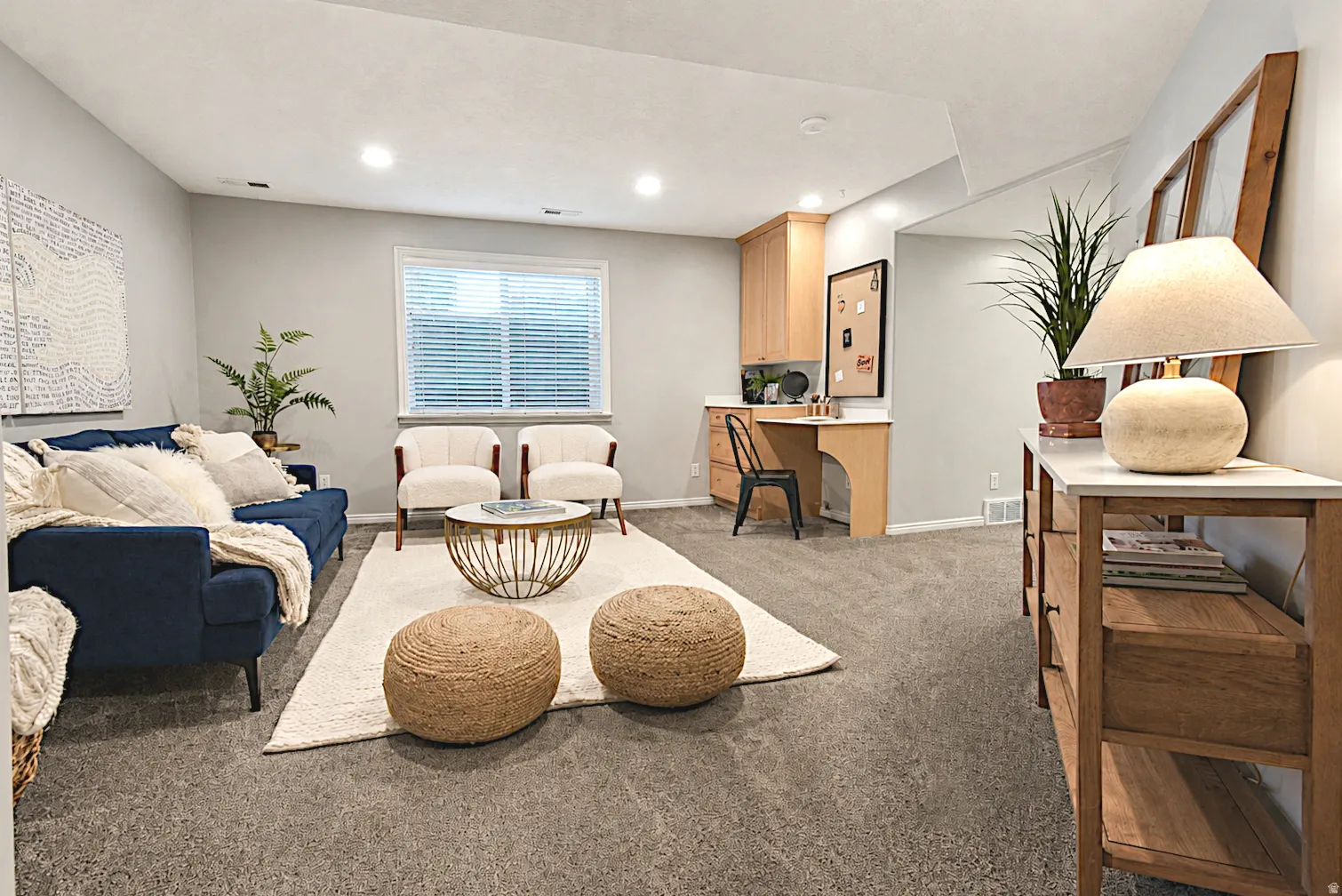 Recessed lighting, built-in desk, wood-finish cabinetry, and window with horizontal blinds