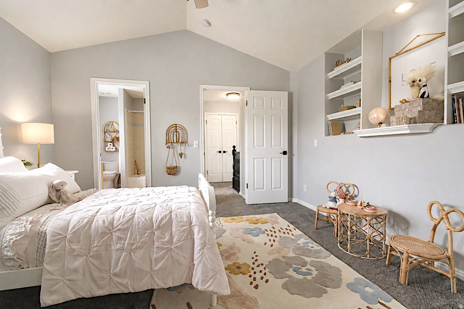 Vaulted ceiling with a ceiling fan, recessed lighting, built-in shelving, and carpet flooring