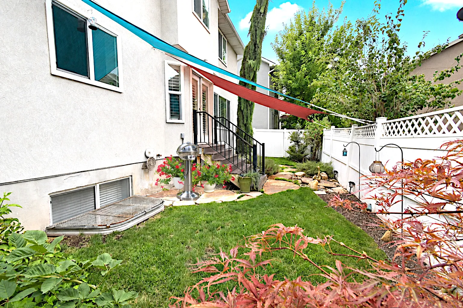 Landscaped backyard with an established lawn