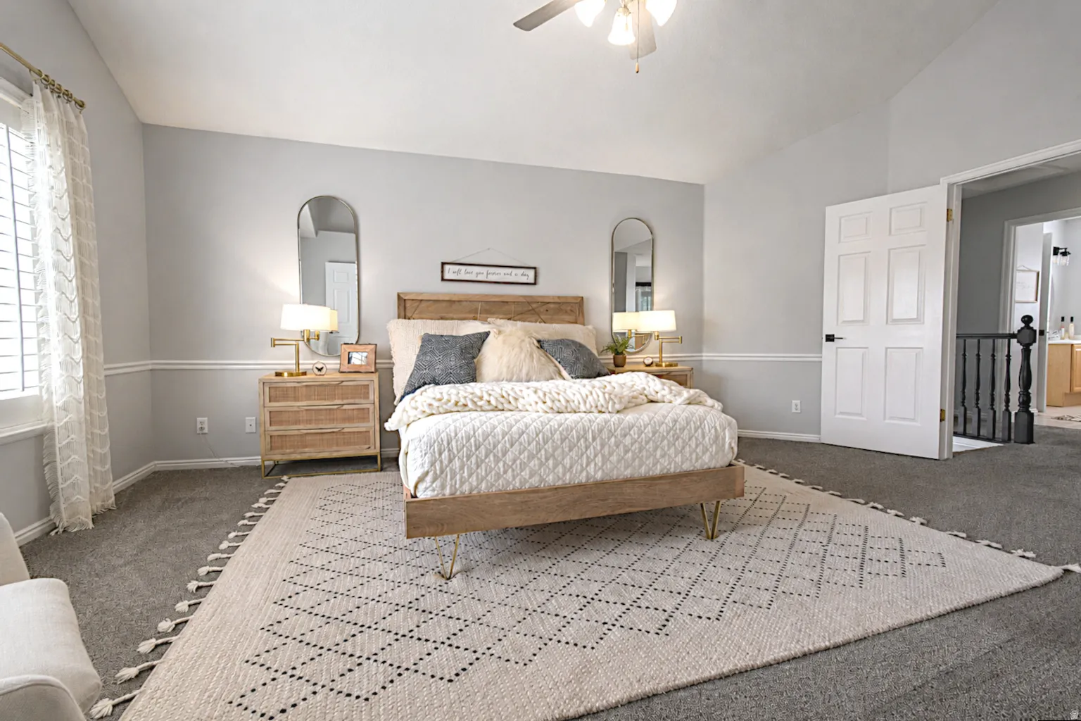 Vaulted ceiling, ceiling fan, carpet flooring, window with shutters