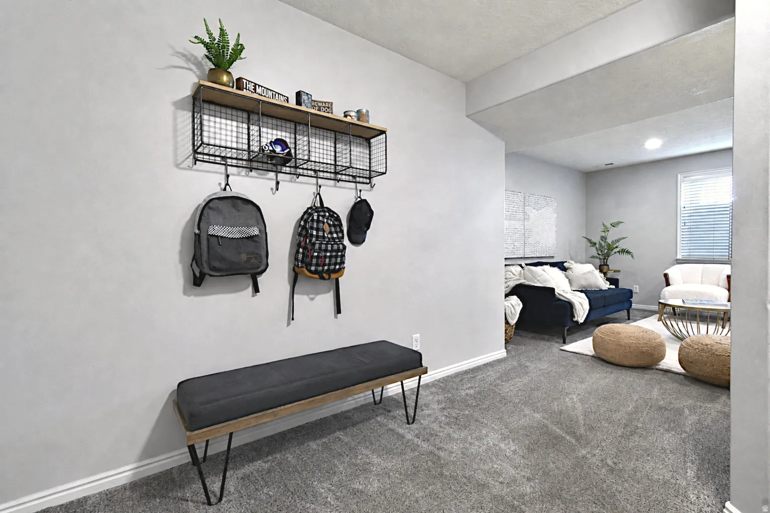 Recessed lighting illuminates plush gray carpeting