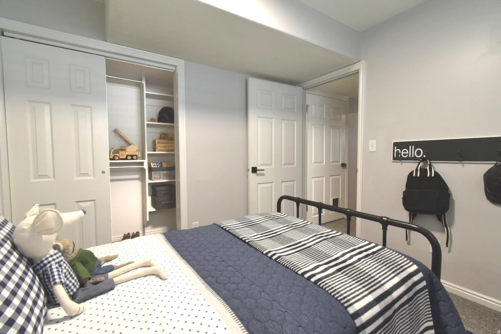 Recessed lighting, painted walls, carpeted flooring, built-in shelving, and white paneled doors