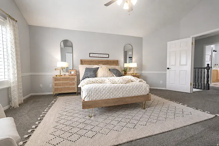 Vaulted ceiling, ceiling fan, carpet flooring, window with shutters