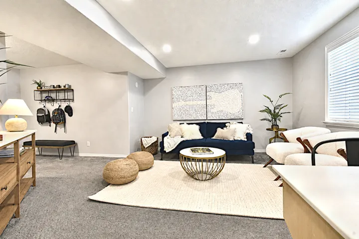 Recessed lighting, light-toned walls, and carpeted flooring