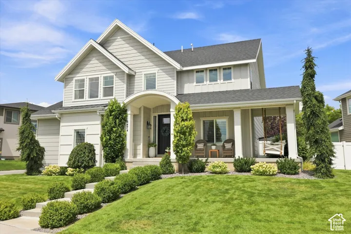 Two-story residence with light gray siding and dark gray roof