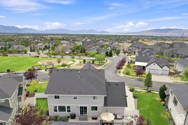 Expansive aerial view showcasing this two-story residence featuring a dark asphalt roof, multi-pane windows, and a modern exterior