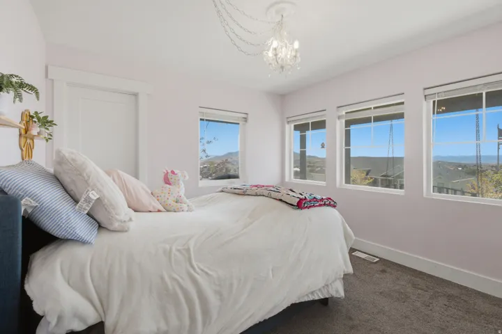 Three expansive windows, overhead chandelier,
