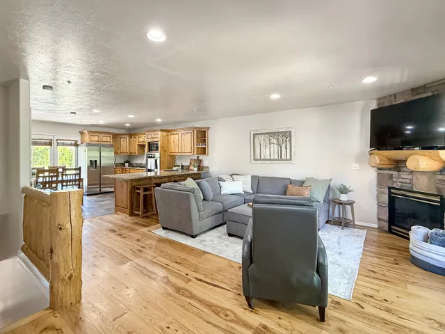 Sold fully furnished and turn-key, open concept kitchen, dining, and living area with real hardwood floors, stone gas log fireplace, and access to the back patio through the kitchen. Kitchen has knotty alder cabinets and beautiful granite ccocuntertops.