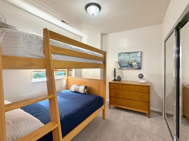Bedroom 2 located in the basement with beautiful furnishings, full over full bunks and large double closet.