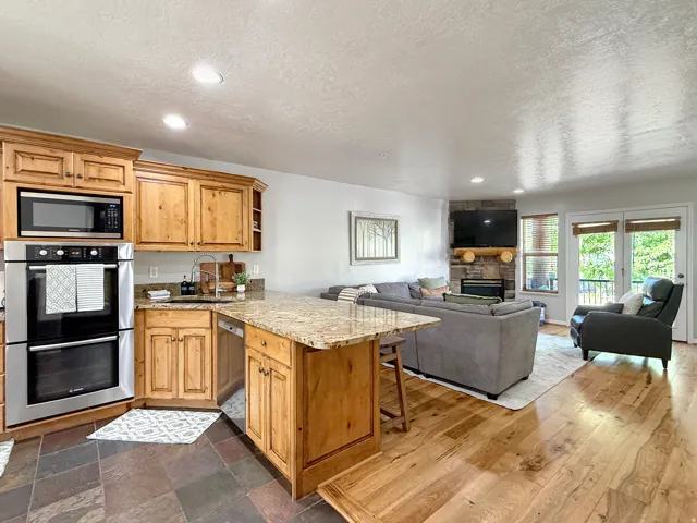 Sold fully furnished and turn-key, open concept kitchen, dining, and living area. Kitchen has knotty alder cabinets, beautiful granite counters, double oven, gas countertop stove, and stainless steel appliances. Kitchen flows seemlessly into the living ro