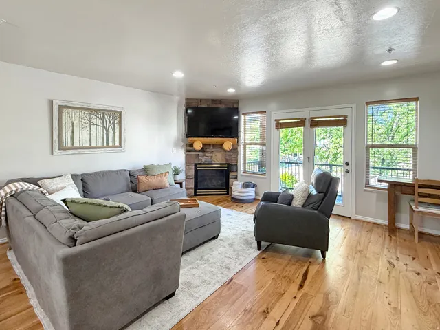 Sold fully furnished and turn-key, open concept kitchen, dining, and living area with real hardwood floors, stone gas log fireplace, and access to the front deck with beautiful mountain views and sunsets.