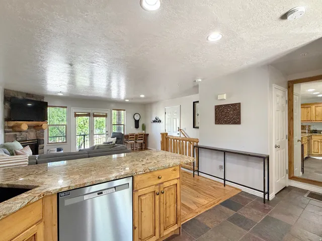 Sold fully furnished and turn-key, open concept kitchen, dining, and living area. Kitchen has knotty alder cabinets, beautiful granite counters, and stainless steel appliances.