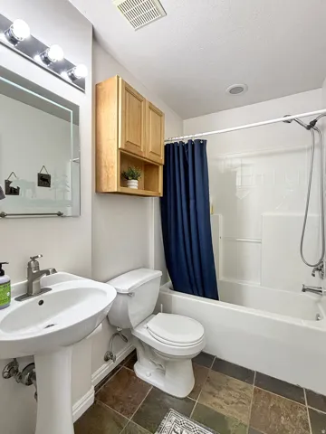 Full bathroom located off the living room and kitchen.