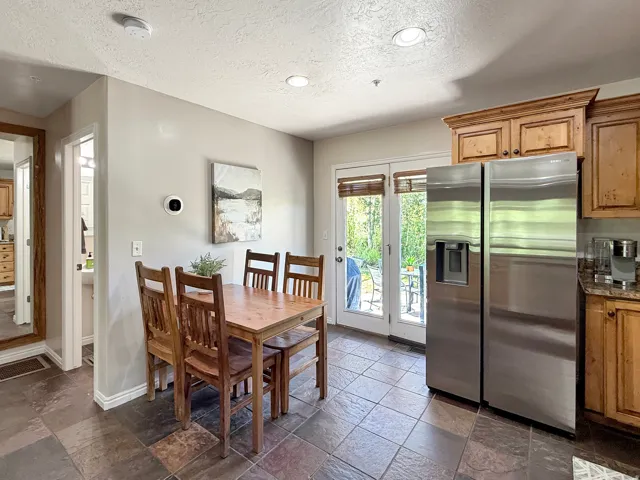 Sold fully furnished and turn-key, open concept kitchen, dining, and living area. Kitchen has knotty alder cabinets, beautiful granite counters, double oven, gas countertop stove, and stainless steel appliances. Access the back patio from the kitchen that
