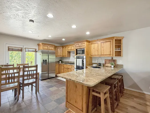 Sold fully furnished and turn-key, open concept kitchen, dining, and living area. Kitchen has knotty alder cabinets, beautiful granite counters, stainless steel appliances, and access to the back patio that backs up to the Wolf Creek Golf Course for no ba