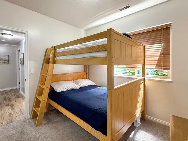 Bedroom 2 located in the basement with beautiful furnishings, full over full bunks and large double closet.