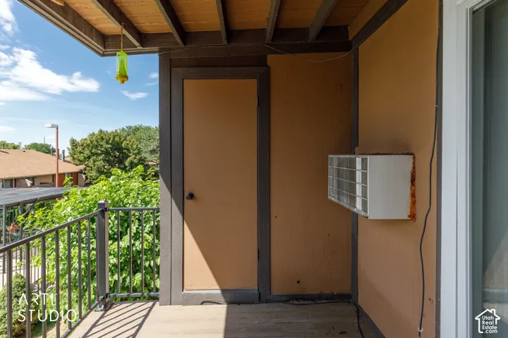Balcony with a dark railing and a wood-finish floor