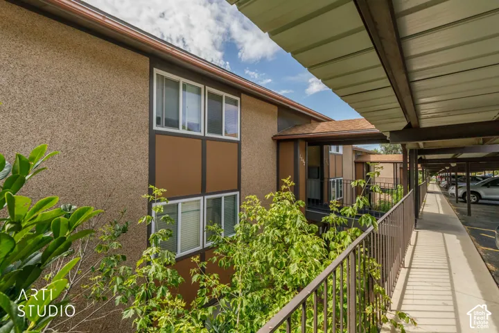 Stucco exterior with multi-pane windows and a covered walkway