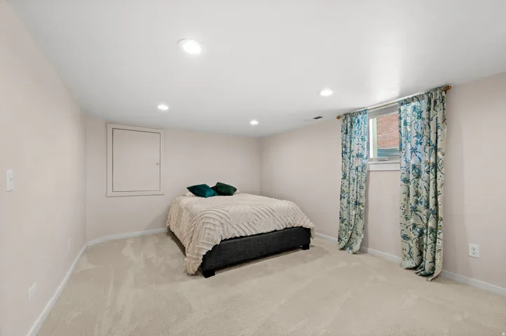 Recessed lighting, wall-to-wall carpeting, single window, and neutral wall tones