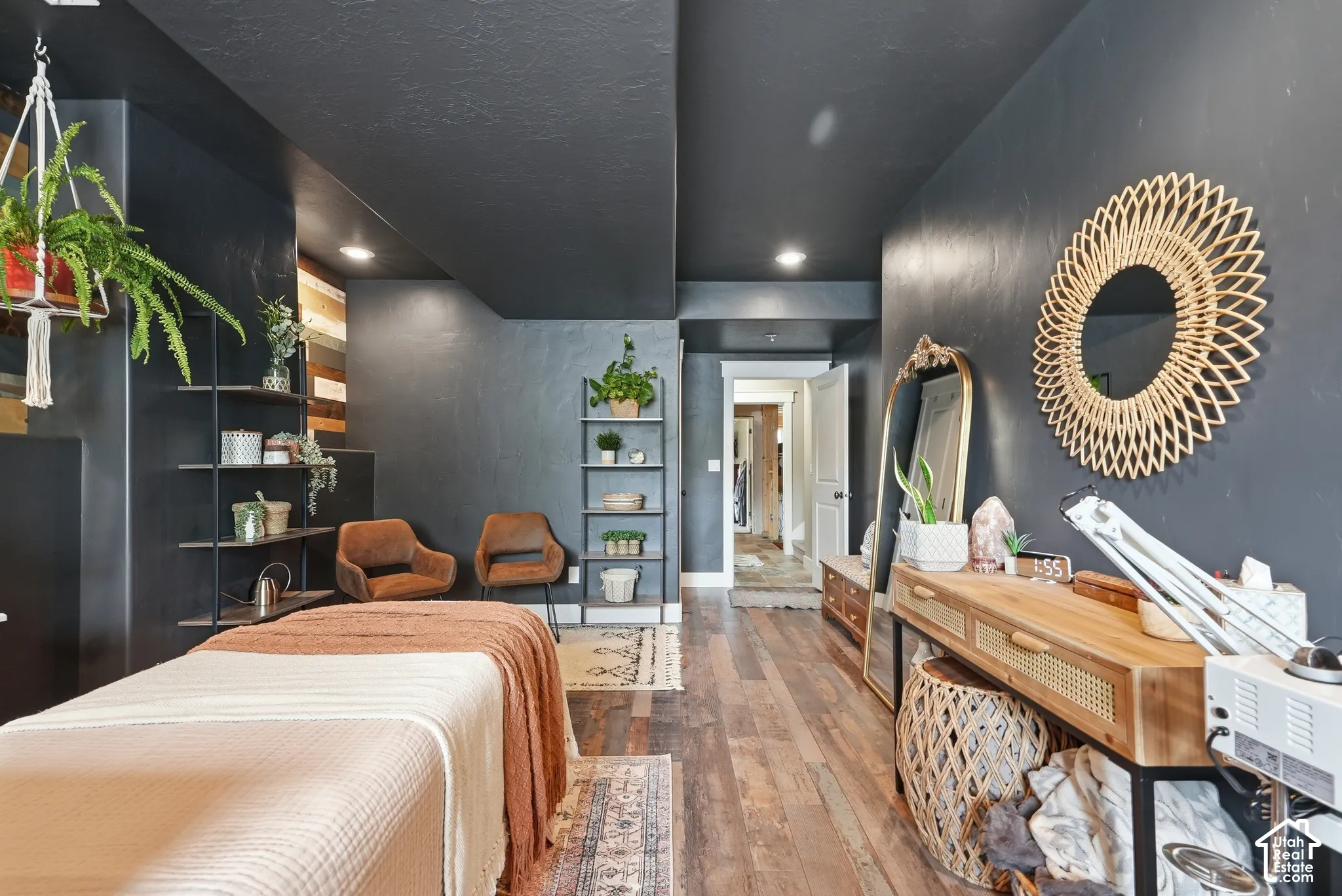 Wood-finish flooring, recessed lighting, built-in shelving, and dark-toned walls