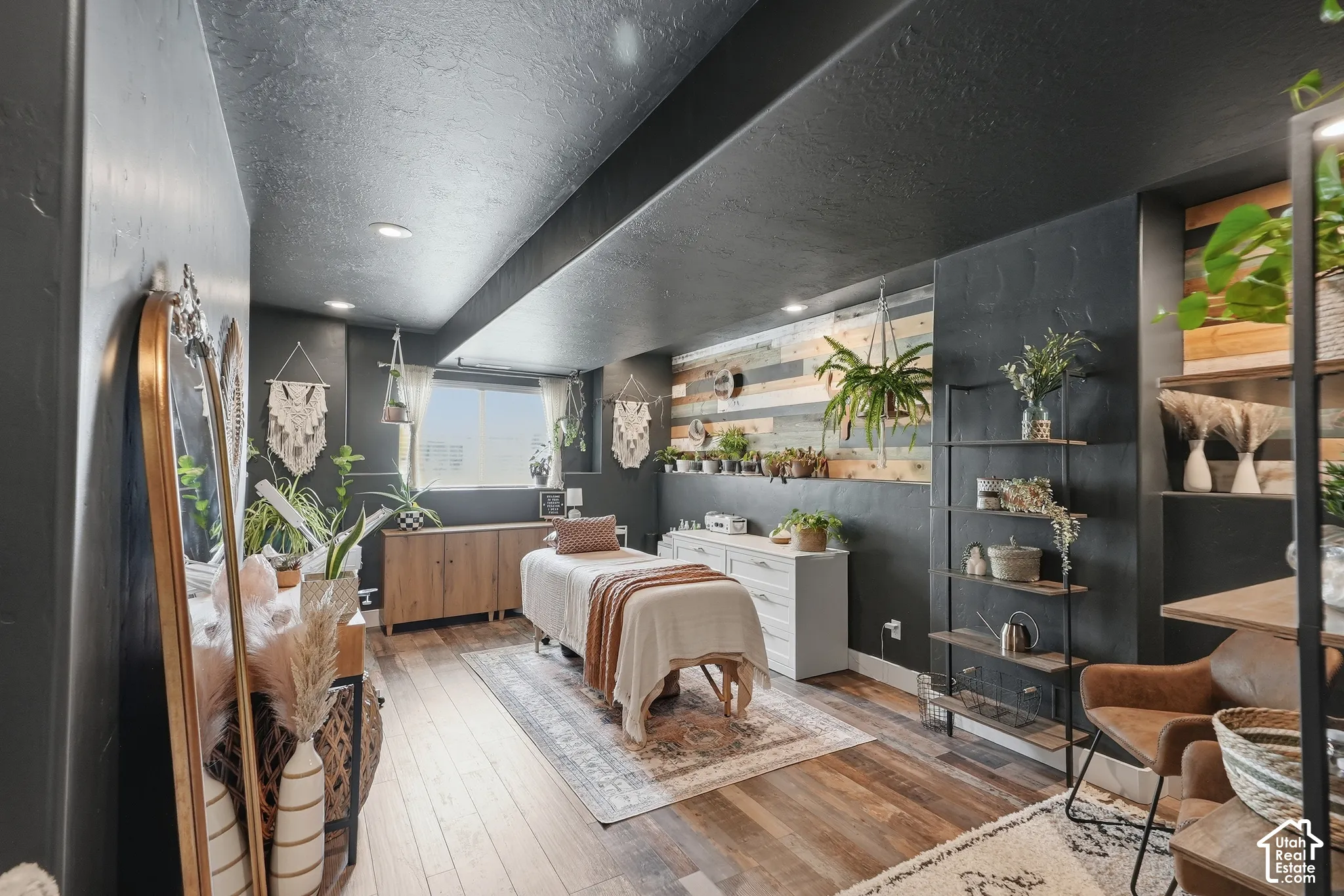 Recessed lighting illuminates wood-finish flooring