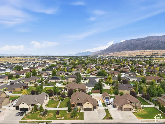 Residential community with varied architectural styles, mature landscaping, and mountain scenery