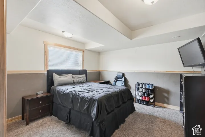 Carpeted flooring, recessed lighting, and a window with wood trim and blinds